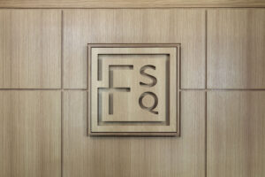 Founders Square emblem on wood paneling
