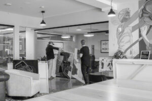 Black-and-white view of people working inside a commercial space