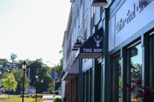 Exterior of The BOP building with hanging storefront sign