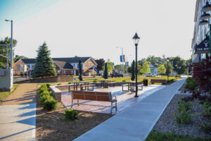Landscaped public plaza with benches, walkways, and streetlamps